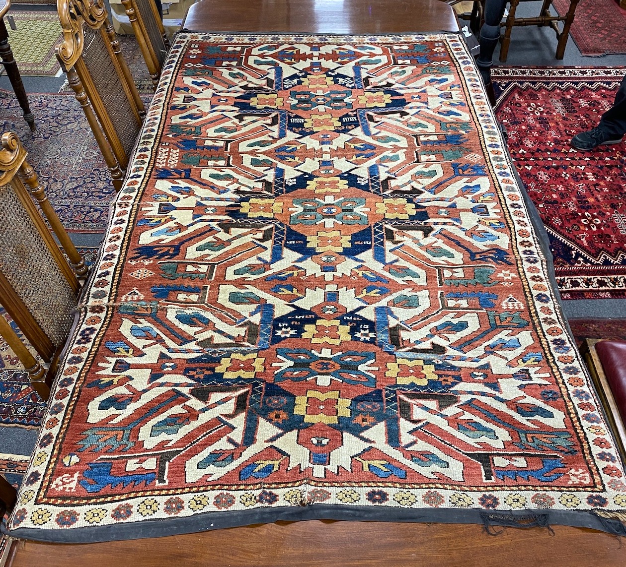 An antique Caucasian ivory ground Karabagh triple medallion rug, 224 x 130cm